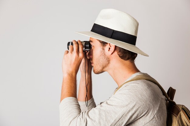 Side view of hipster man with binoculars