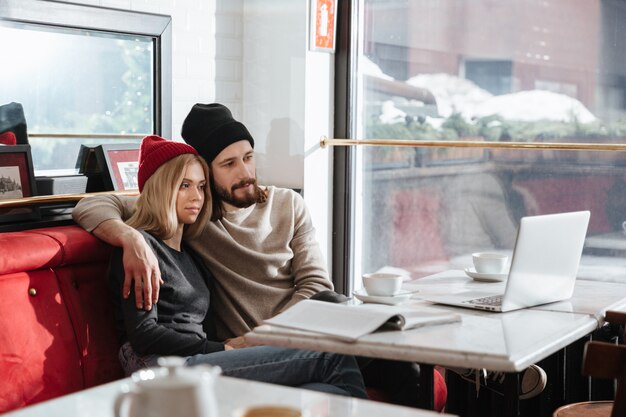 Side view of hipsters looking at laptop