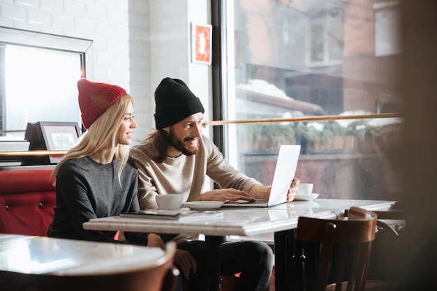 Side view of hipsters with laptop