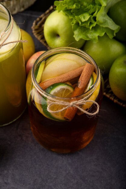 Side view iced lemon tea with cinnamon apple lime and lettuce