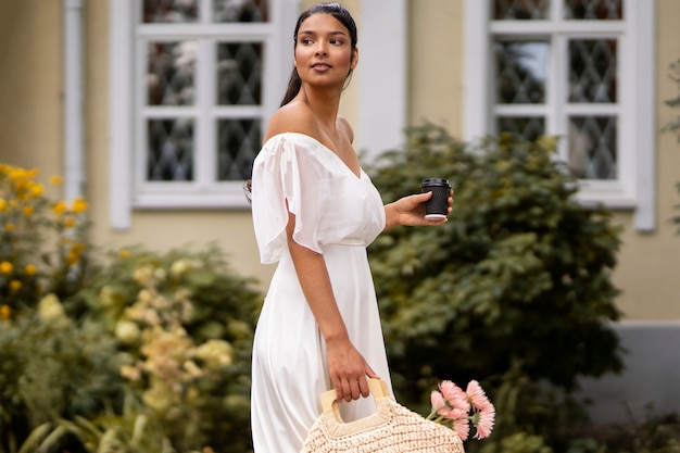 Side view indian woman carrying bag