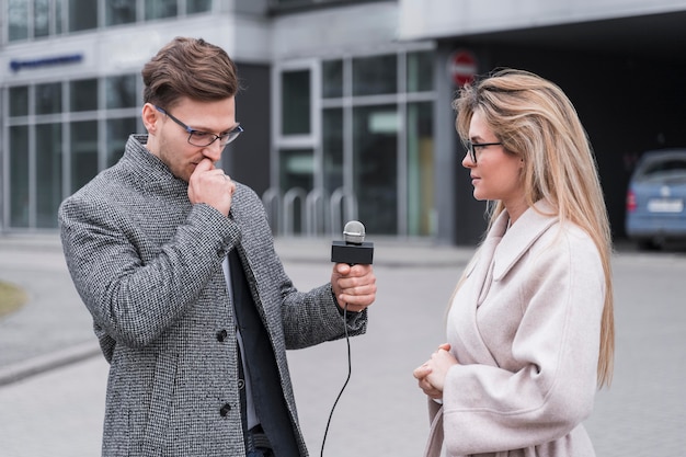 Side view journalist interviewing woman