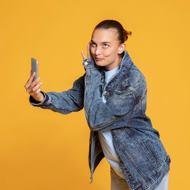 Side view of joyful woman holding smartphone