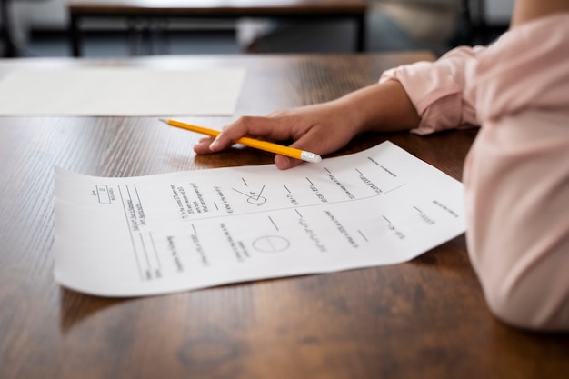 Free photo side view kid cheating at school test