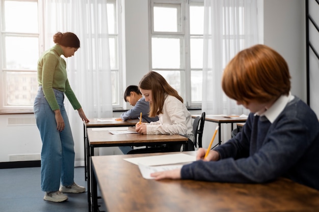 Free photo side view kid cheating at school test