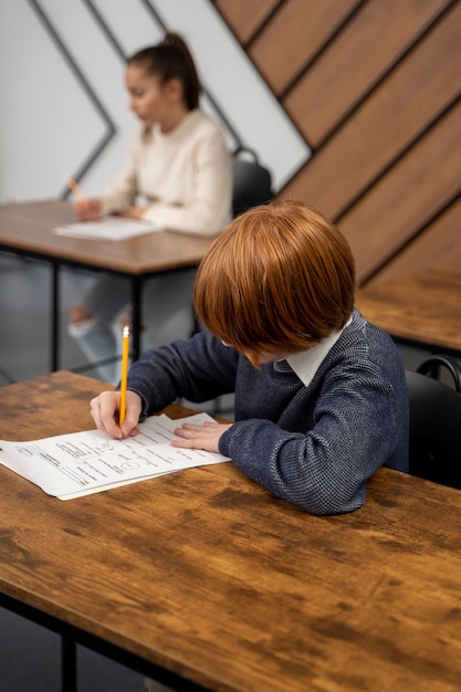 Free photo side view kid cheating at school