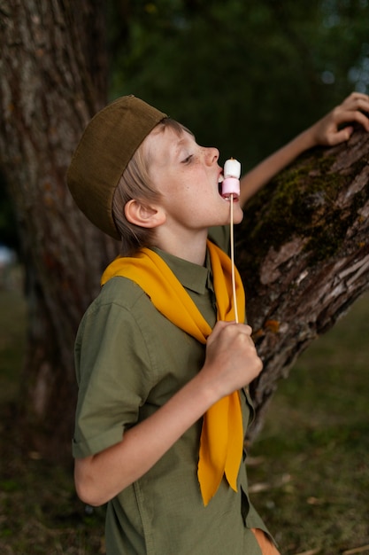Side view kid eating marshmallows