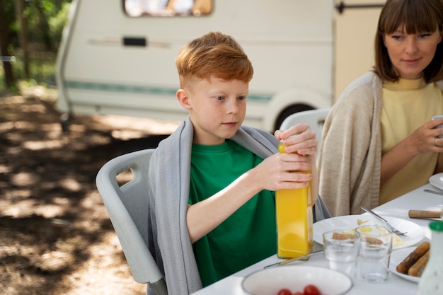 Side view kid holding juice bottle