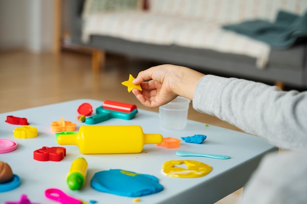 Side view kid playing with playdough