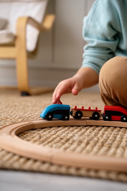 Side view kid playing with train