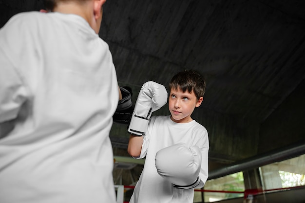 Free photo side view kid practicing boxing