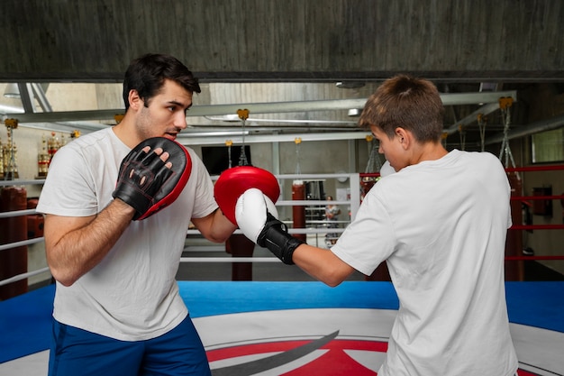 Free photo side view kid practicing boxing