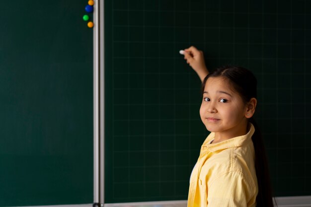 side view kid writing on board