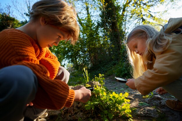 Side view kids exploring nature together