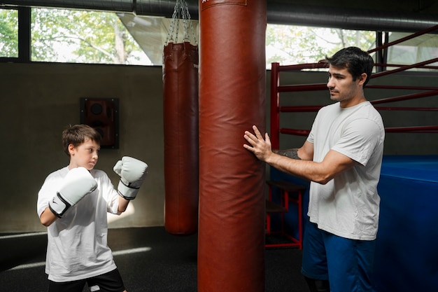 Free photo side view kids learning boxing