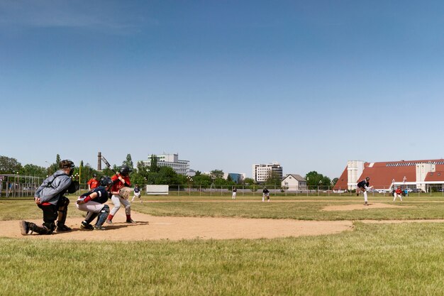 Side view kids playing kickball on field