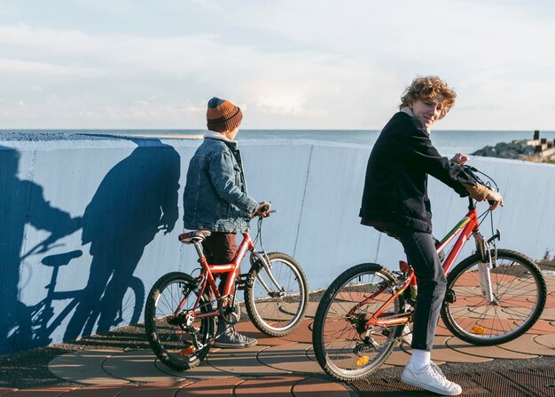 Side view of kids riding bicycles outdoors