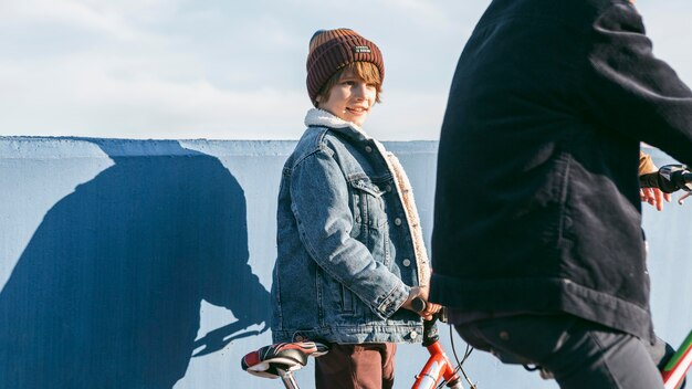 Side view of kids riding bicycles outside