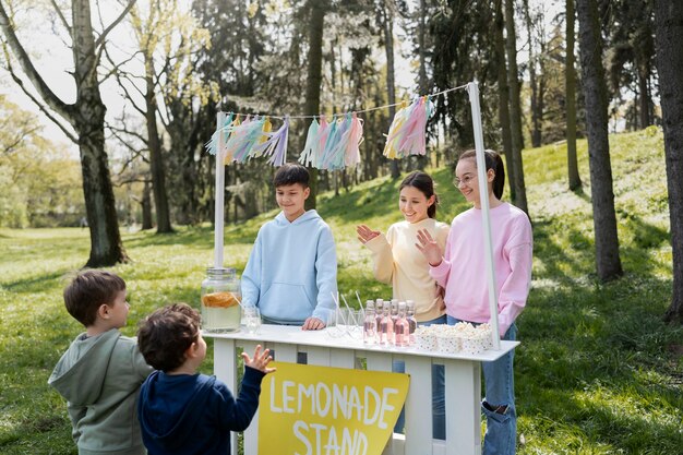 Side view kids selling lemonade