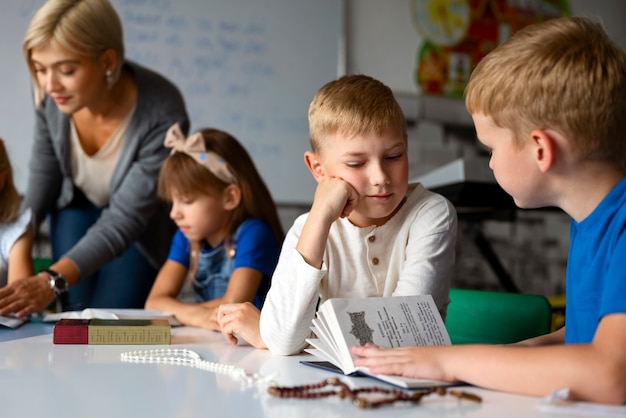 Side view kids with bible at sunday school