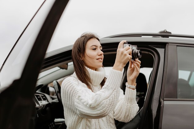 Side view lady taking a photo