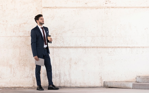 Side view lawyer with tablet and coffee