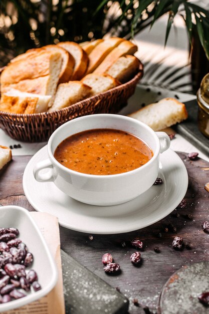 Side view of lentil cream soup in a white bowl