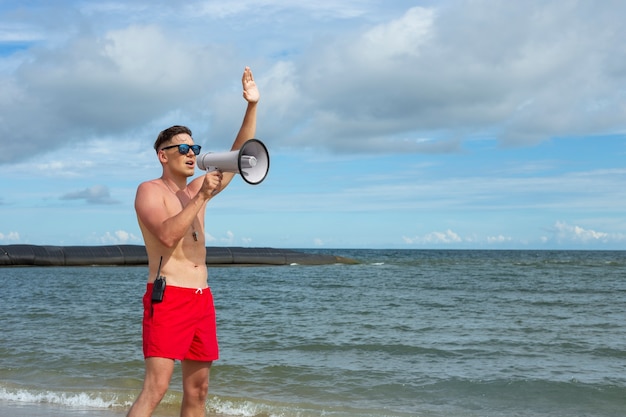 Free photo side view lifeguard on beach