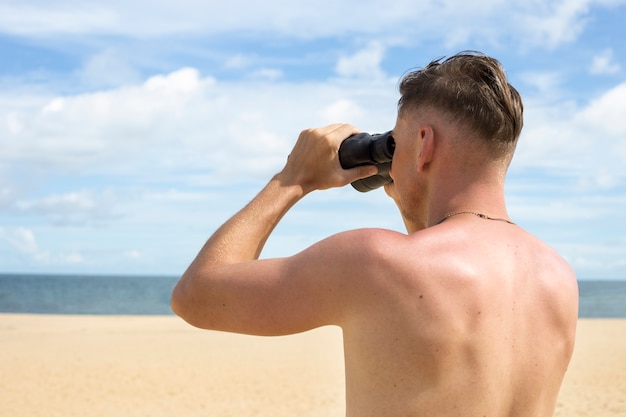 Side view lifeguard with binoculars