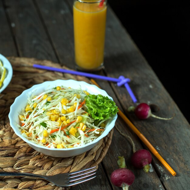 Side view light cabbage salad with corn and juice