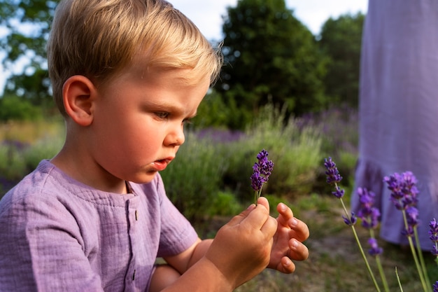 Side view little kid holding lavender