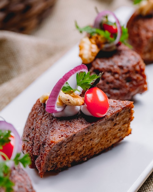 Side view liver pat with onion and cherry tomato