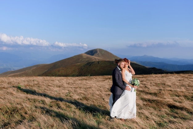 Side view of love story of a beautiful couple outdoors on a sunny day