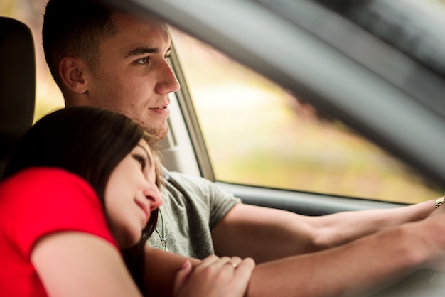 Free photo side view of lovely couple in car