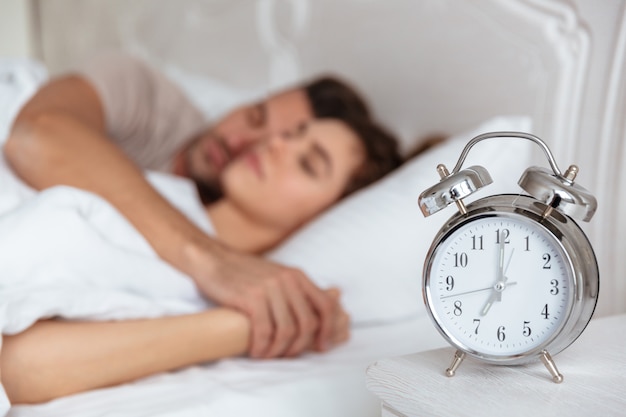 Side view of Lovely couple sleeping together in bed