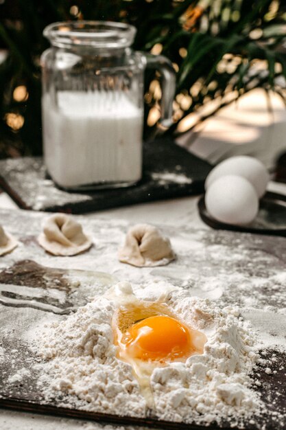 Side view of making turkish manti with dough and yolk