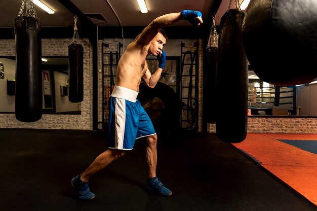 Side view of male boxer training