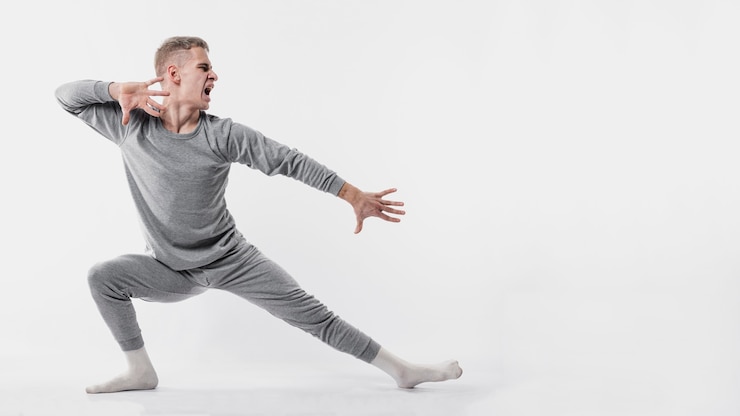 Free Photo side view of male dancer in tracksuit and socks posing