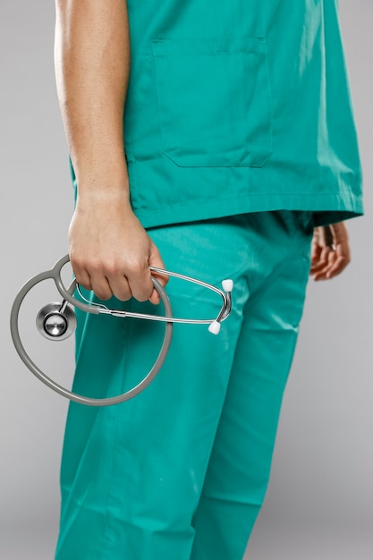 Side view of male doctor holding stethoscope