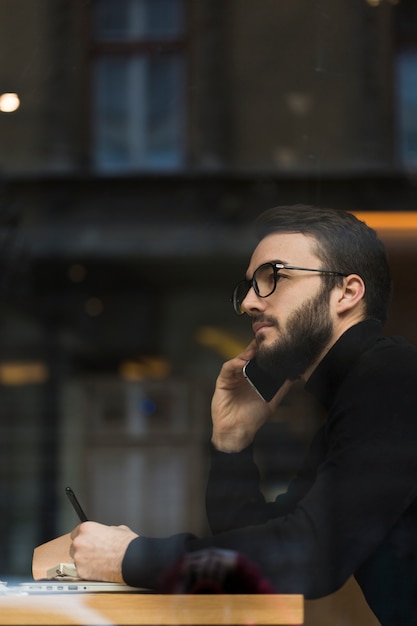 Side view male talking over phone