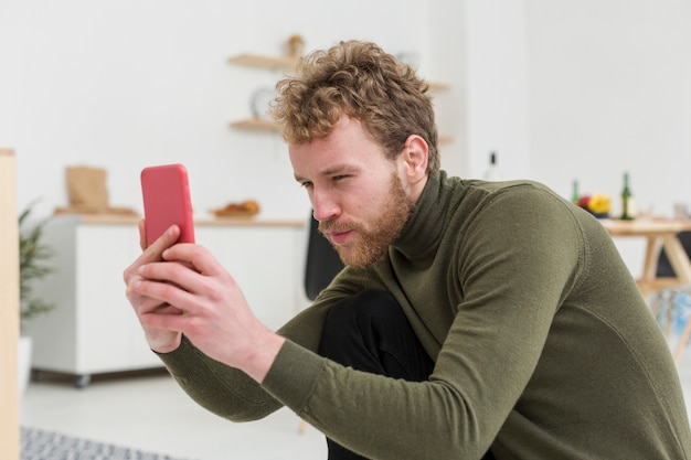 Side view male with phone taking photos