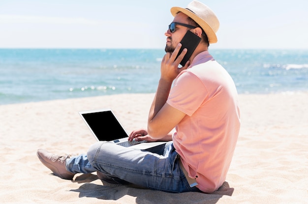 Side view of man on beach working