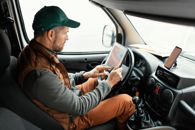 side view man in car delivering package