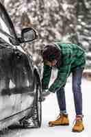 Free photo side view man checking car