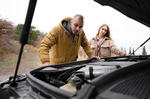 Side view man checking engine