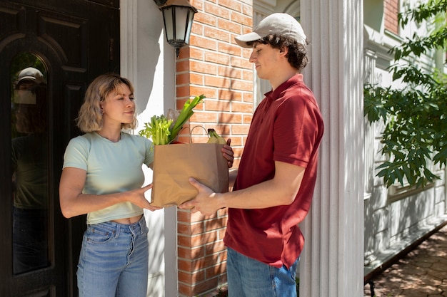 Side view man delivering groceries