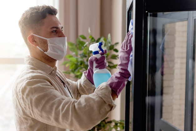 Side view man disinfecting room