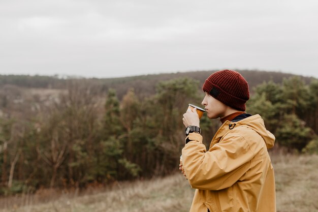 Side view of man drinking tea