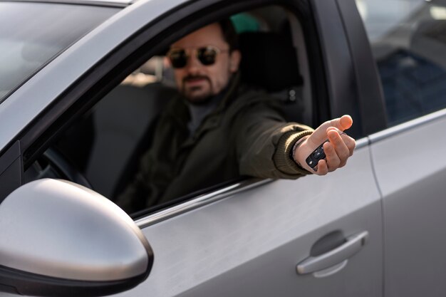 Side view man driving car