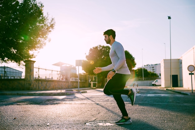 Side view man exercising in mornin